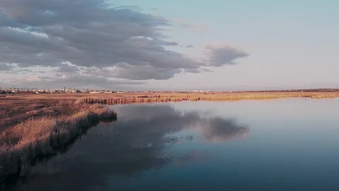 Flight over the lake during sunset Stock Footage 128616901