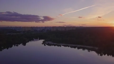 Flight over the lake during sunset overlooking the city with beautiful clouds Stock Footage 143453551