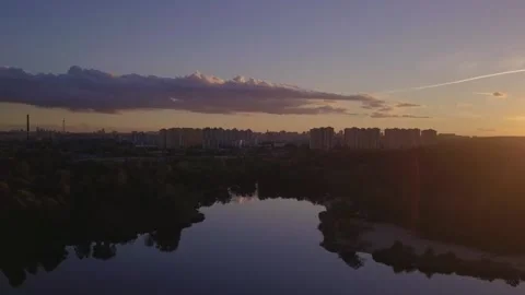 Flight over the lake during sunset overlooking the city with beautiful clouds Stock Footage 145953261