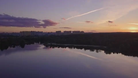 Flight over the lake during sunset overlooking the city with beautiful clouds Stock Footage 147491805