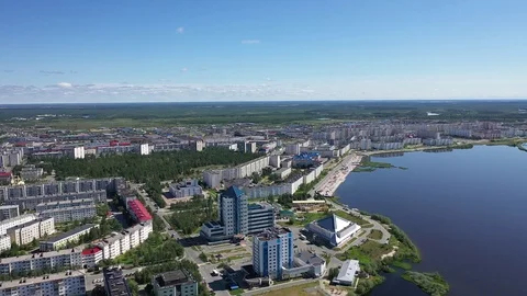 Flight over the lake with views of the Russian city of Nadym in the Yamal-Nenets Stock Footage 112142464
