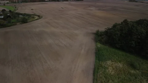 Flight over a large and empty field without plants 스톡 동영상 220453087