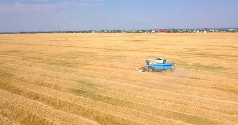 Flight over a large combine in a field Stock Footage 112881049