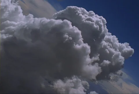 A flight over a large cumulus cloud formation banks over and through the top of Stock Footage 86832483