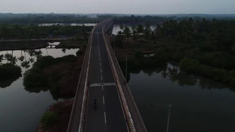 Flight over a long bridge over the river in Goa. Aerial view. Stock Footage 84971042