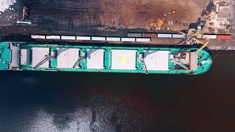 Flight over the long freight ship standing at the quay. Cargo ship in the modern Stock Footage 339750336