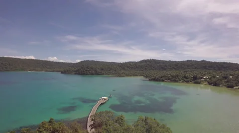 Flight over a long wooden path way through a tropical jungle Stock Footage 64790424
