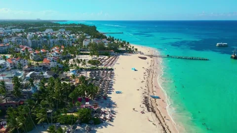 Flight over Los Corales beach on a bright sunny day in Bavaro Punta Cana Stock Footage 307562247