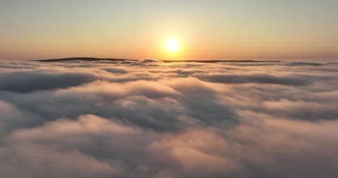 Flight over low hanging clouds at sunrise Stock Footage 248912341
