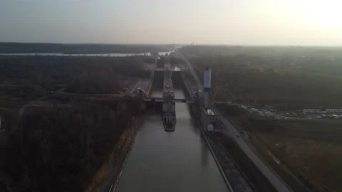 Flight over major lock system with cargo ships Stock Footage 229011089