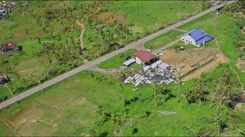 Flight over mass graves with body bags after typhoon Haiyan Stock-Footage 33769805