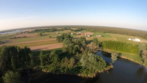 Flight over the meadows and trees and river Stockbeeldmateriaal 89454318