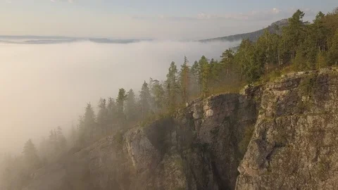 Flight over a misty forest and rocks at morning aerial Stock Footage 93728481