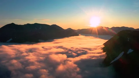 Flight over the mountain gorge full of clouds towards to the sun. Stock Footage 142736010