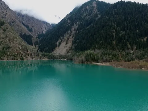 Flight over the mountain lake Issyk. Kazakhstan. Ile-Alatau National Park. Stock Footage 79758542