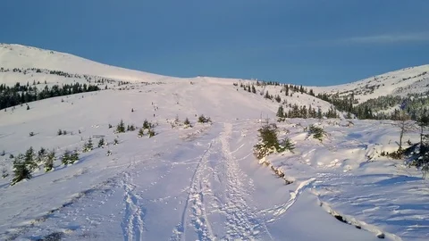 Flight over the mountain path in the winter mountains Stock Footage 100897995