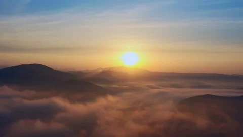 Flight over mountain peaks and clouds at sunrise, Primorsky Krai, Russia Stock Footage 118540202