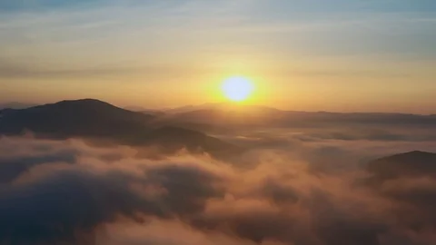 Flight over mountain peaks and clouds at sunrise, Primorsky Krai, Russia Stock Footage 118540262