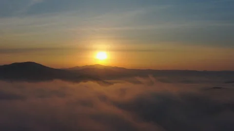 Flight over mountain peaks and clouds at sunrise, Primorsky Krai, Russia Stock Footage 118540949
