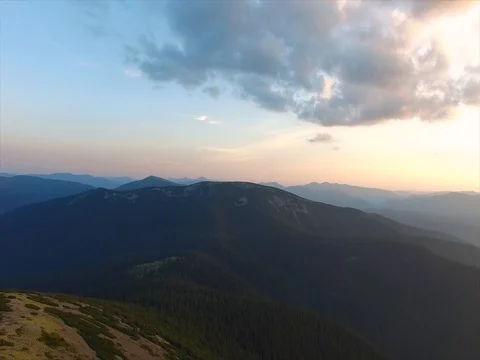 Flight over mountain ranges covered with forest Stock Footage
