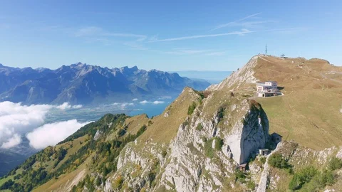 Flight over mountain ridge to railway terminal station with Lake Geneva Stock Footage 123788981