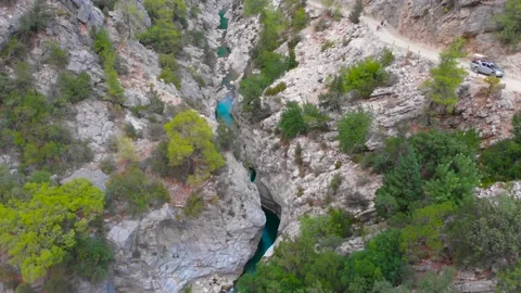 Flight over a mountain river and a trail to a gorge among a coniferous forest Stock Footage 162567793