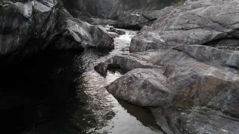 Flight over the mountain river between rocks and vegetation Stock Footage 118779359