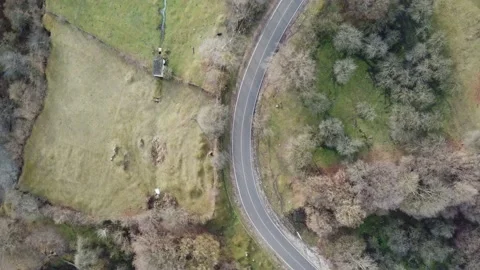 Flight over a mountain road, winter without snow, green grass, pastures, par Stock Footage 167264092