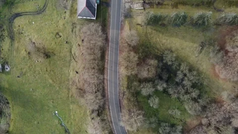 Flight over a mountain road, winter without snow, green grass, pastures, par Stock-Footage 167264109