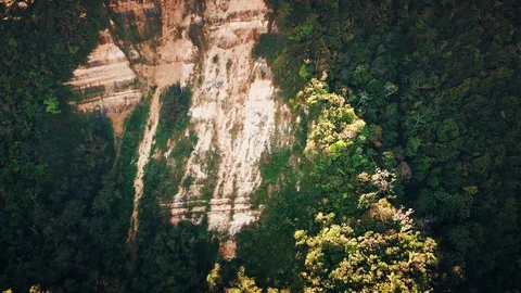 Flight over the mountain with rocks overgrown with tropical green forest Stock Footage 101758259