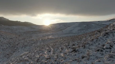Flight over the mountain slope in the snow Stock Footage 105681909