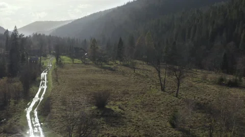 Flight over the mountain valley and the village Stock Footage 221324984