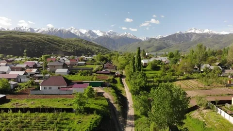 Flight over the mountain village in spring. Beautiful landscape . Kazakhstan Stock Footage 148144661