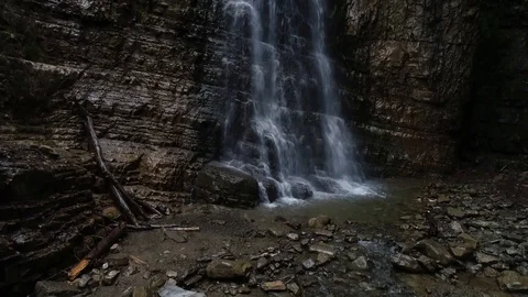 Flight over a mountain waterfall. Video stock 90494877