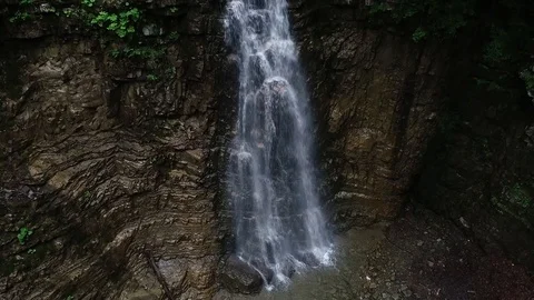 Flight over a mountain waterfall. Video stock 90494892