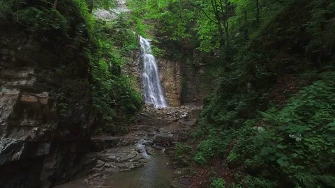 Flight over a mountain waterfall. Video stock 90494914