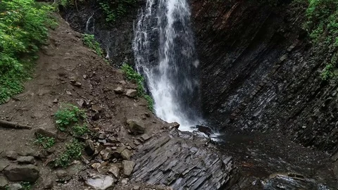 Flight over a mountain waterfall. Video stock 90494926
