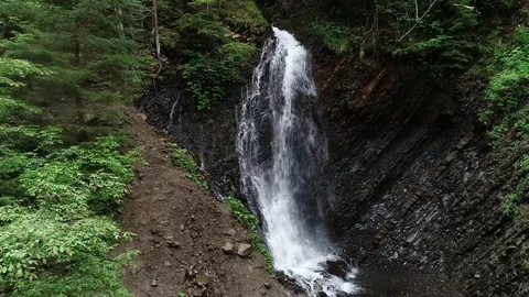 Flight over a mountain waterfall. Video stock 90494938