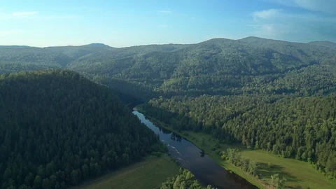 Flight over the mountainous forest area on a sunny morning. Stock Footage 114977044