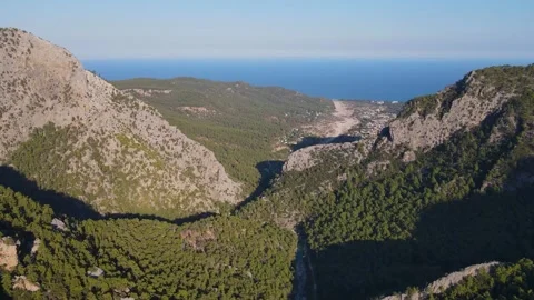 Flight over the mountains and see the Mediterranean Sea on the horizon in Turkey Stock Footage 168402667