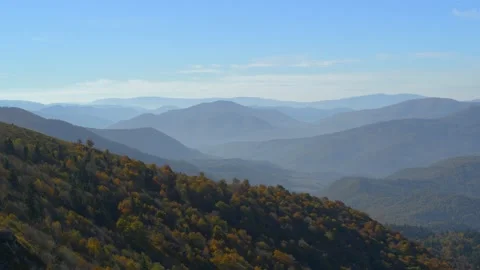 Flight over mountains with autumn forests. There are distant peaks on the Video stock 219940603