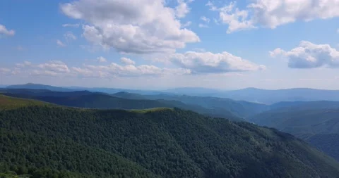 Flight over mountains covered with dense forests Stock Footage 167653221