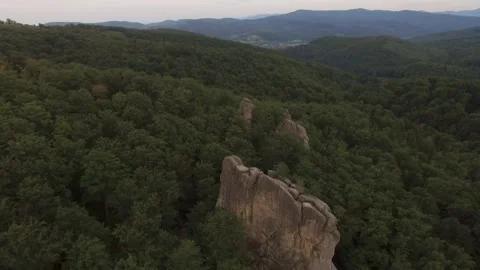 Flight over Mountains Peaks, Sunset Flight above forest an mountains, over rocks Stock Footage 213605223