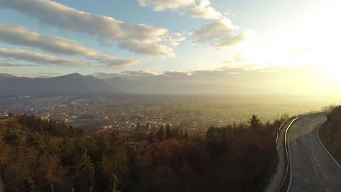 Flight over the mountains side's road at dawn  Stock Footage 72314910