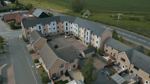 Flight over a new housing development car coming into park Stock Footage 296820194