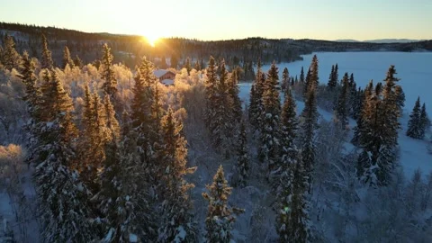Flight over Norwegian mountain cottage during winter time Stock Footage