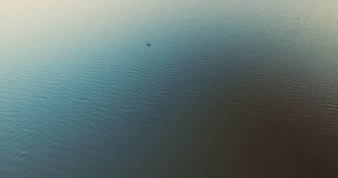 Flight over ocean blue water and alone rowing boat with man Stock Footage 101460721