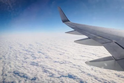 Flight over an ocean of clouds towards NYC Stock Photos
