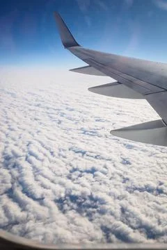 Flight over an ocean of cottony clouds towards NYC Stock Photos
