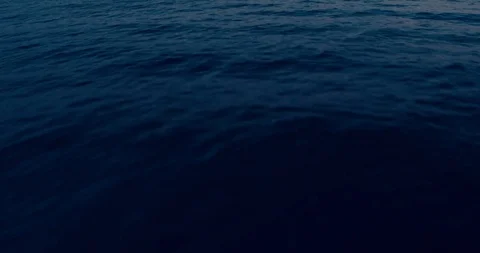 A flight over the ocean with a drone tilting the camera. Stock Footage 94537869